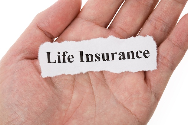 A piece of paper in a hand that says "life insurance"