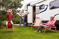 Family Enjoying Camping Holiday with Camper Van
